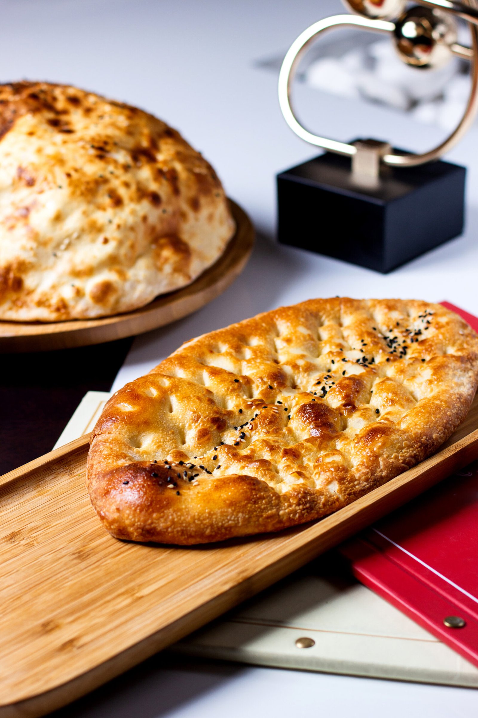 fresh tender bread sprinkled with sesame seeds on a wooden board